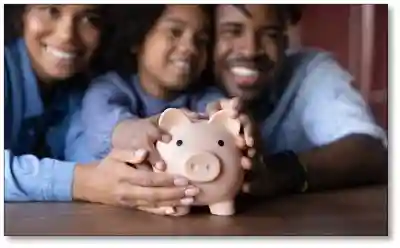 Family holding a piggy bank